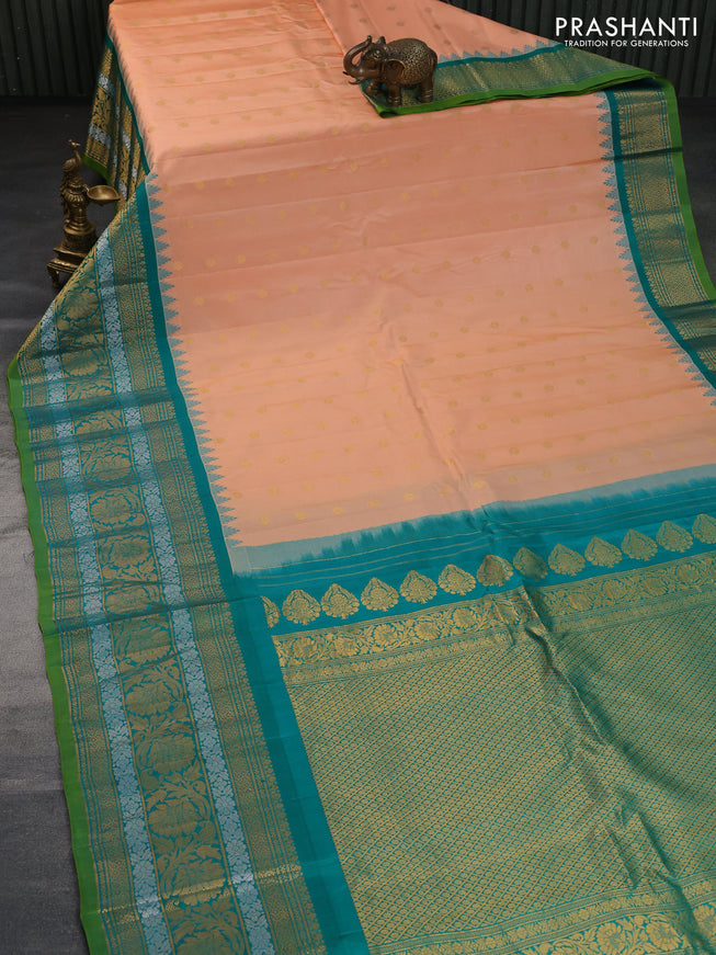 Pure gadwal silk saree pale orange and green with floral zari woven buttas and temple deisgn long zari woven border