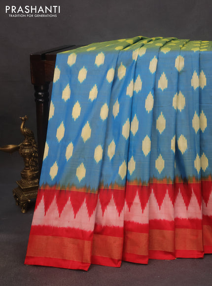 Pochampally silk saree dual shade of cs blue and red with allover ikat butta weaves and zari woven border