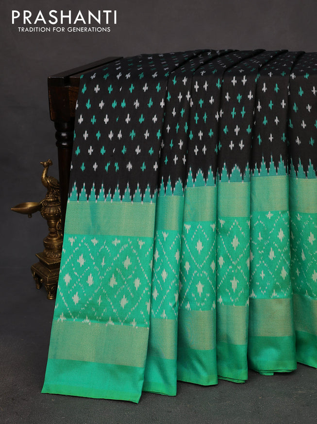 Pochampally silk saree black and teal green shade with allover ikat butta weaves and long zari woven ikat style border