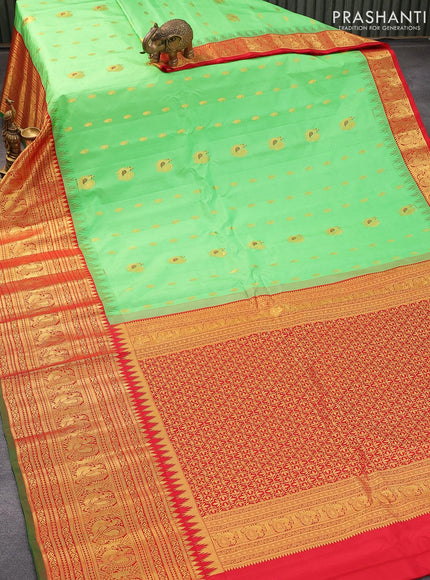 Pure gadwal silk saree light green and red with zari woven buttas and temple design annam zari woven border