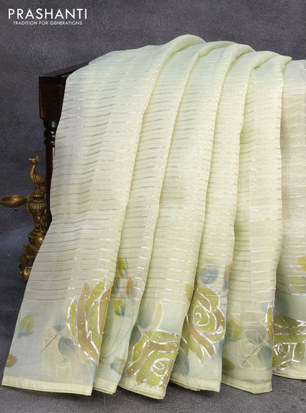 Pure organza silk saree pista green with allover silver zari stripes pattern and floral design beaded work border