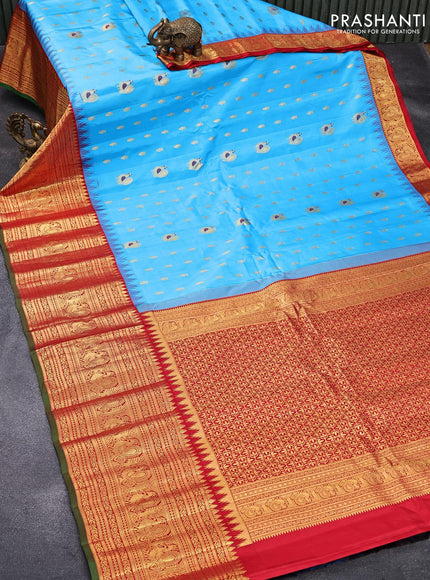 Pure gadwal silk saree light blue and red with allover zari woven buttas and temple design long annam zari woven border