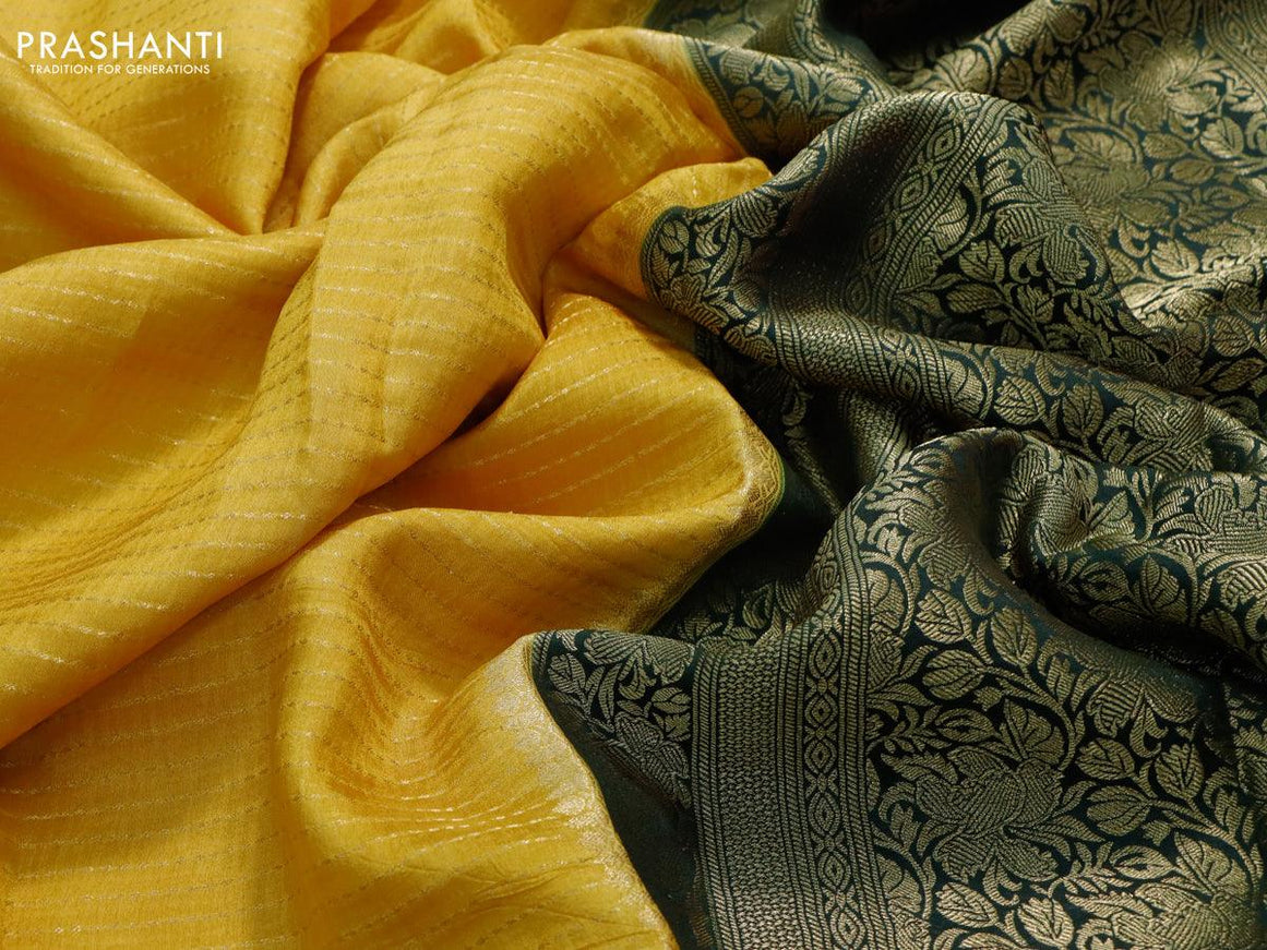 Dola silk saree yellow and bottle green with allover zari stripe weaves and zari woven border & zari butta blouse