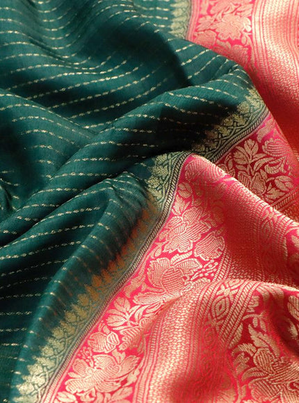 Dola silk saree bottle green and pink with allover zari stripe weaves and zari woven border & zari butta blouse