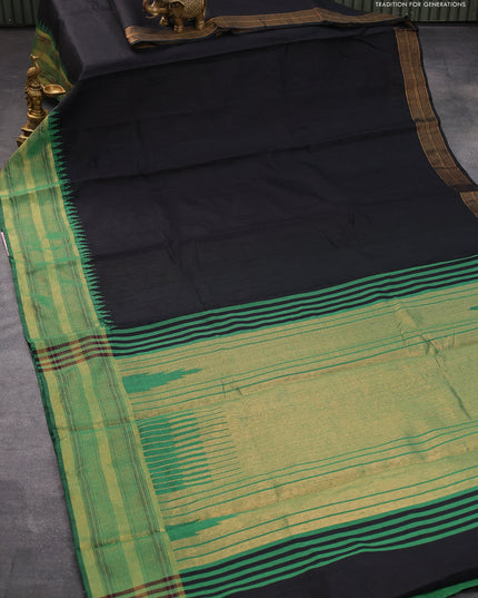Dupion silk saree black and green with plain body and temple design zari woven border