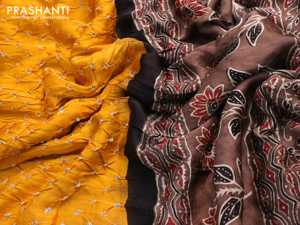 Modal silk saree yellow and brown with allover bandhani prints and ajrakh printed pallu