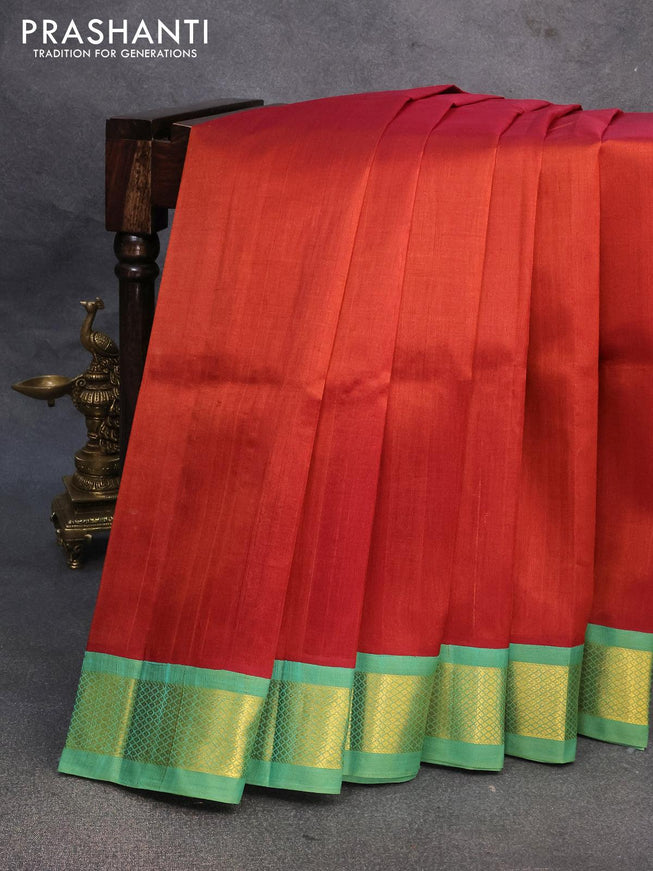 Silk cotton saree rust shade and teal green with plain body and zari woven korvai border