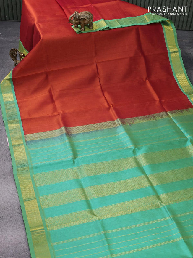 Silk cotton saree rust shade and teal green with plain body and zari woven korvai border