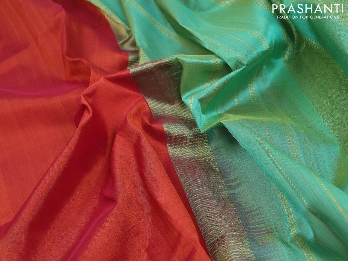 Silk cotton saree rust shade and teal green with plain body and zari woven korvai border