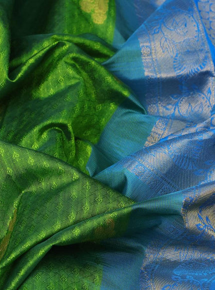 Silk cotton saree green and cs blue with allover self emboss jacquard & zari buttas and zari woven border