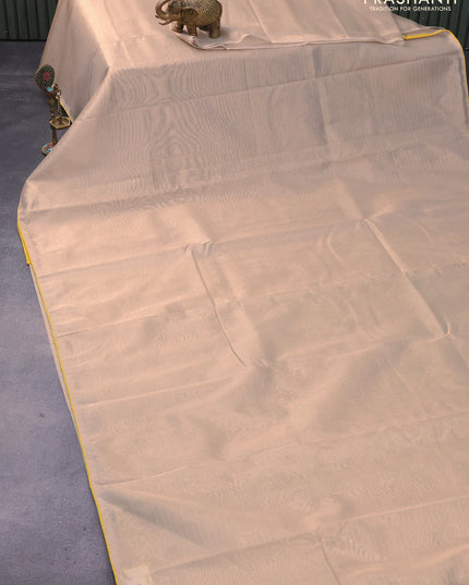 Tissue saree cream and yellow with allover zari stripe pattern and piping border & banarasi blouse