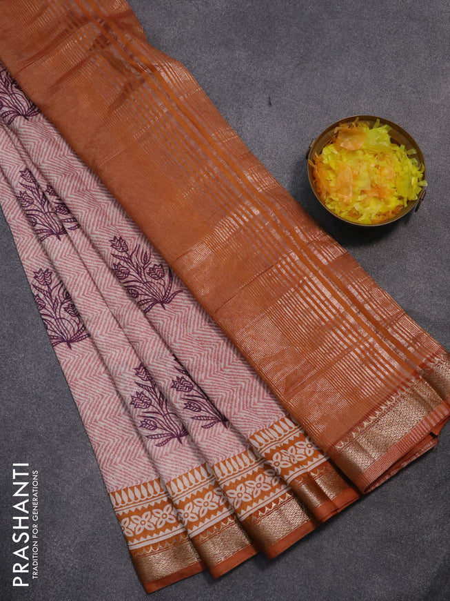 Semi gadwal saree off white pastel shade and dark mustard with allover prints and zari woven border