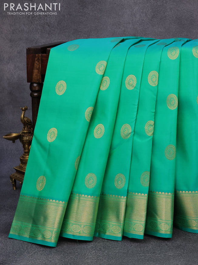 Pure kanjivaram silk saree dual shade of teal green with paisley zari woven buttas and rich zari woven border butta style