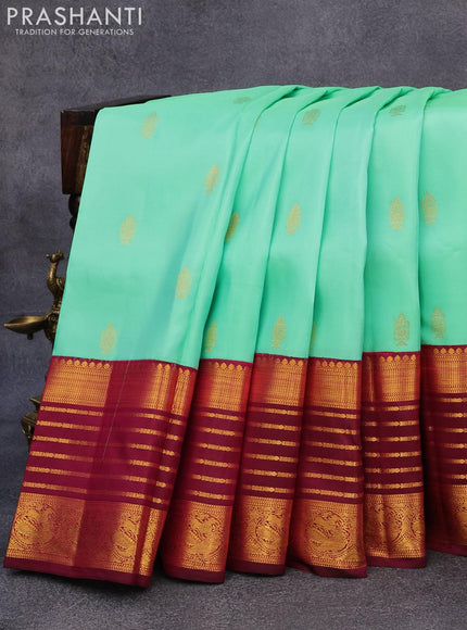 Pure kanjivaram silk saree teal green shade and dark magenta pink with allover zari woven annam buttas and long rich zari woven korvai border butta style