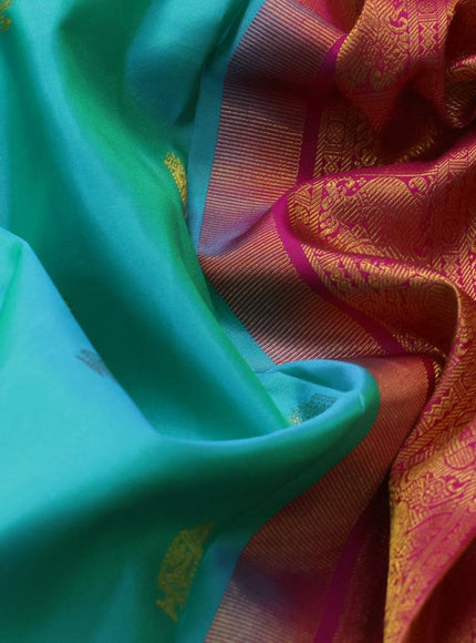 Pure kanjivaram silk saree dual shade of teal bluish green and pink with allover zari woven annam buttas and long rich zari woven korvai border butta style