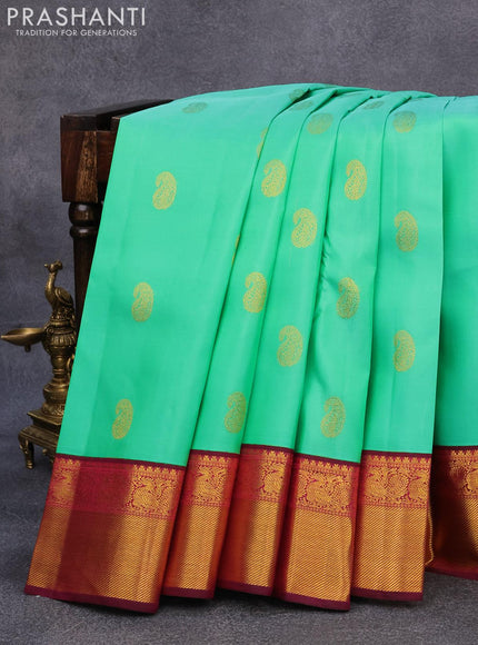 Pure kanjivaram silk saree teal green shade and dark magenta with paisley zari woven buttas and rich annam zari woven border butta style