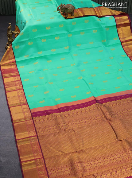 Pure kanjivaram silk saree teal green shade and dark magenta with paisley zari woven buttas and rich annam zari woven border butta style