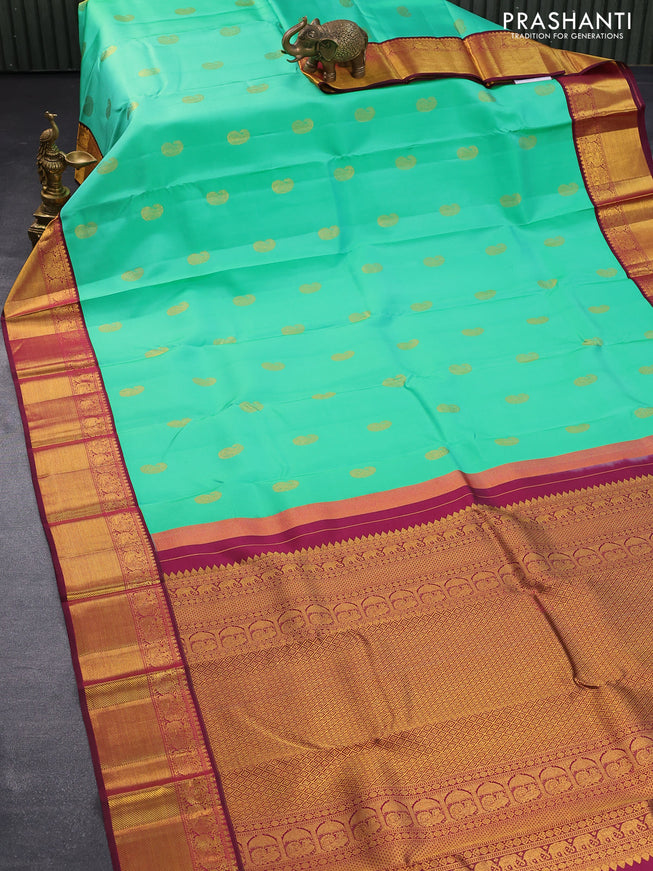 Pure kanjivaram silk saree teal green shade and dark magenta with paisley zari woven buttas and rich annam zari woven border butta style