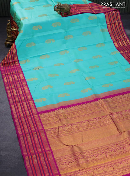 Pure kanjivaram silk saree teal blue shade and purple with paisley zari woven buttas and rich annam & rudhraksha zari woven korvai border butta style