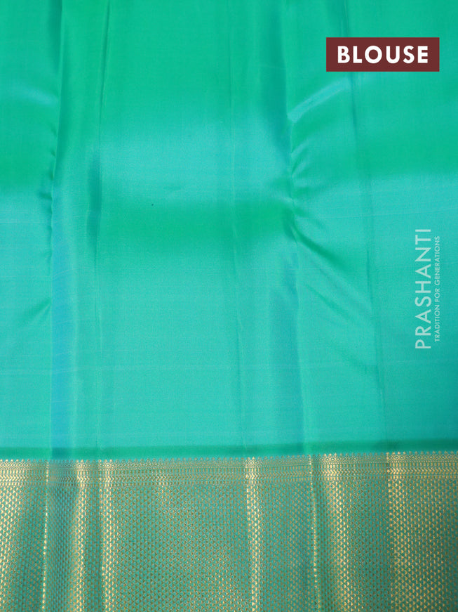 Pure kanjivaram silk saree dual shade of pinkish orange and teal green with plain body and rich zari woven border plain body