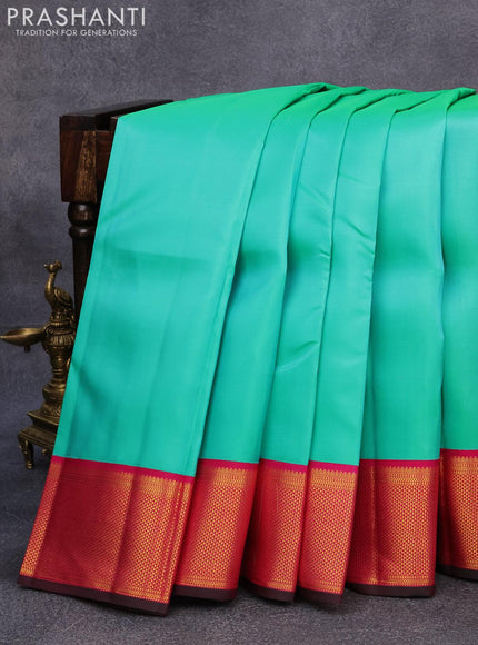 Pure kanjivaram silk saree teal green and pink with plain body and rich zari woven border plain body