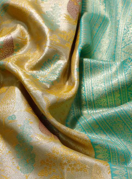 Tissue semi kanjivaram saree yellow and teal blue with allover brocade weaves and long zari woven border