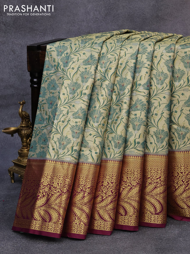 Tissue semi kanjivaram saree cream dark green and wine shade with allover floral brocade weaves and long zari woven border