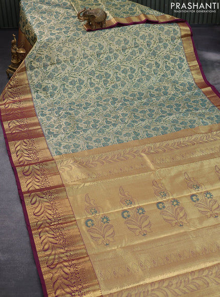 Tissue semi kanjivaram saree cream dark green and wine shade with allover floral brocade weaves and long zari woven border