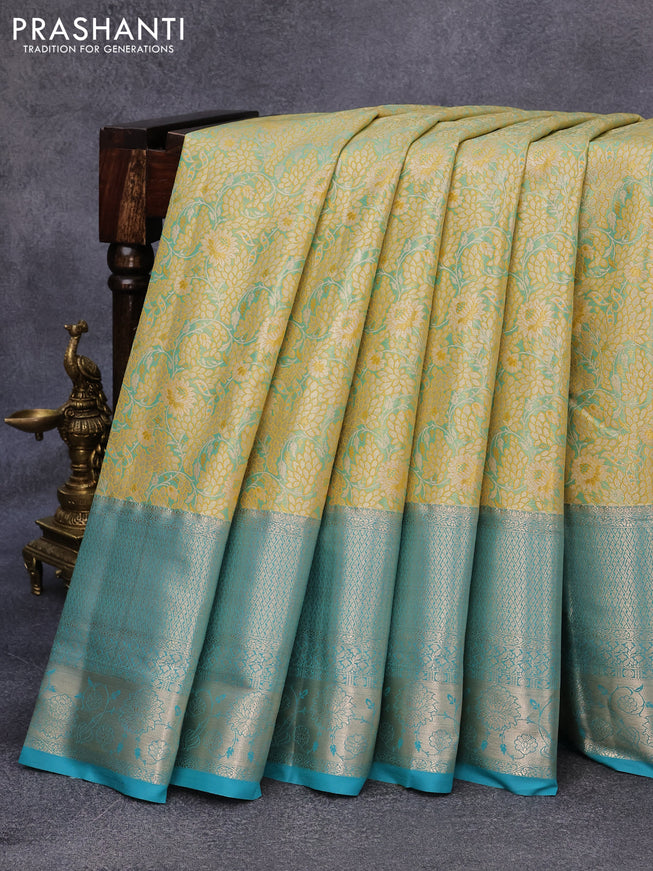 Tissue semi kanjivaram saree yellow shade and teal blue with allover floral brocade weaves and long zari woven border