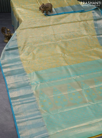 Tissue semi kanjivaram saree yellow shade and teal blue with allover floral brocade weaves and long zari woven border