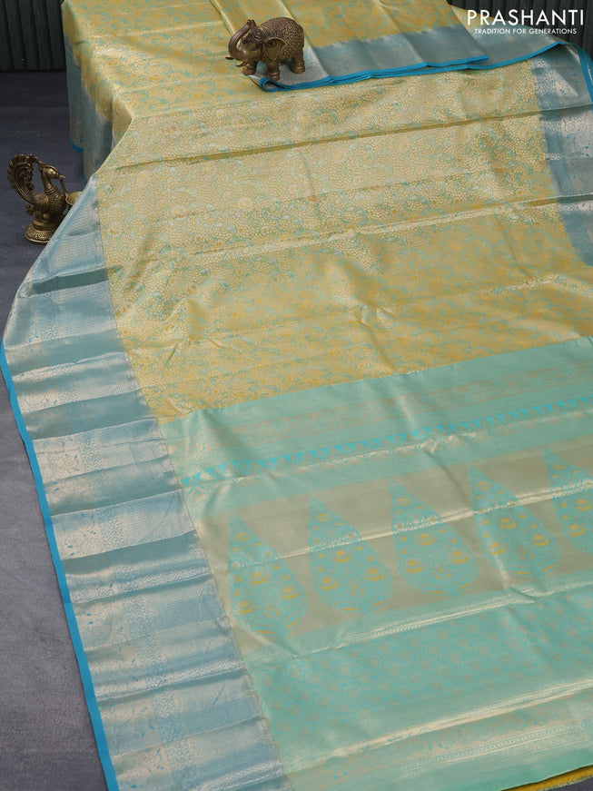 Tissue semi kanjivaram saree yellow shade and teal blue with allover floral brocade weaves and long zari woven border