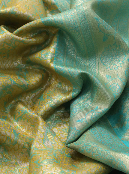 Tissue semi kanjivaram saree yellow shade and teal blue with allover floral brocade weaves and long zari woven border