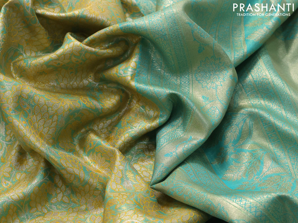 Tissue semi kanjivaram saree yellow shade and teal blue with allover floral brocade weaves and long zari woven border