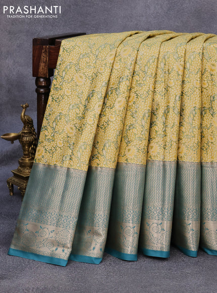 Tissue semi kanjivaram saree mustard shade and peacock green with allover floral brocade weaves and long zari woven border