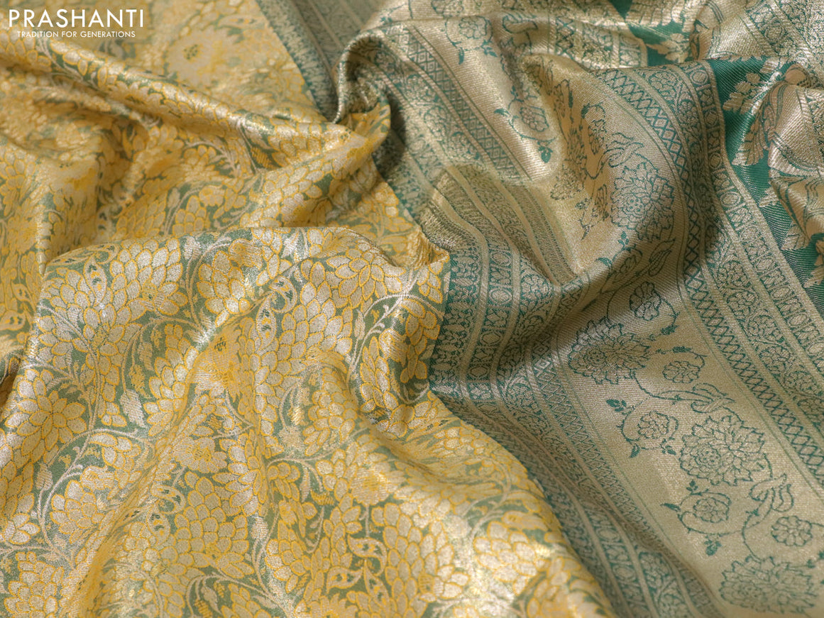 Tissue semi kanjivaram saree mustard shade and peacock green with allover floral brocade weaves and long zari woven border