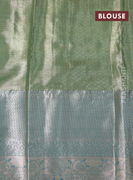 Tissue semi kanjivaram saree mustard shade and peacock green with allover floral brocade weaves and long zari woven border