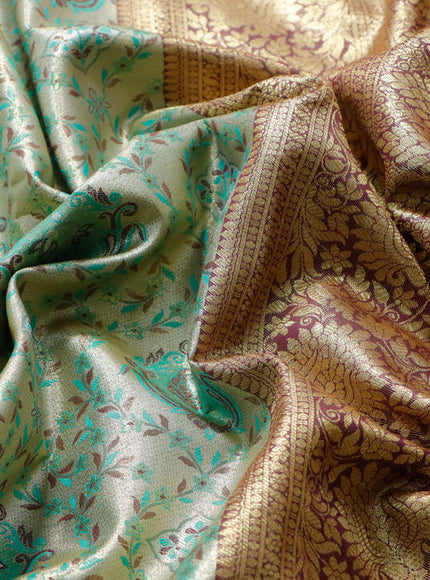 Tissue semi kanjivaram saree beige teal green and maroon with allover brocade weaves and floral zari woven border