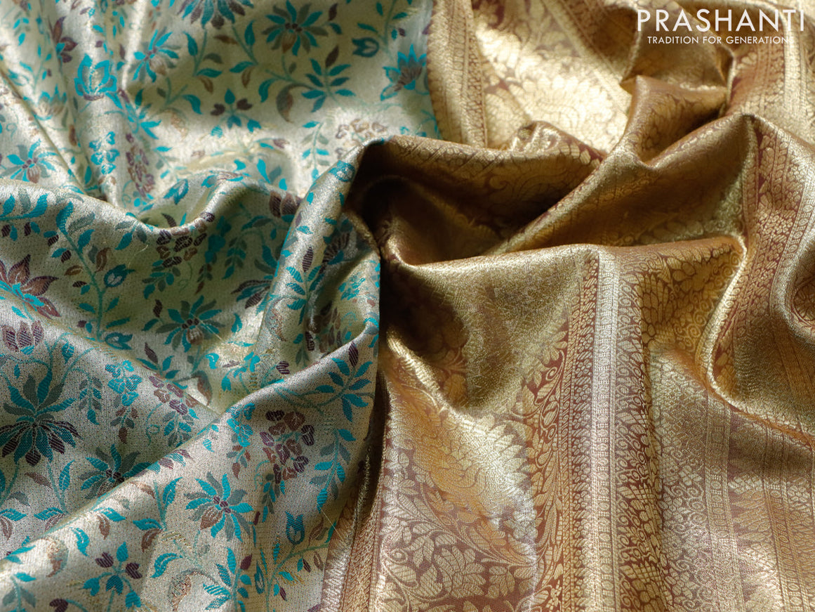 Tissue semi kanjivaram saree cream teal green and wine shade with allover floral brocade weaves and floral zari woven border