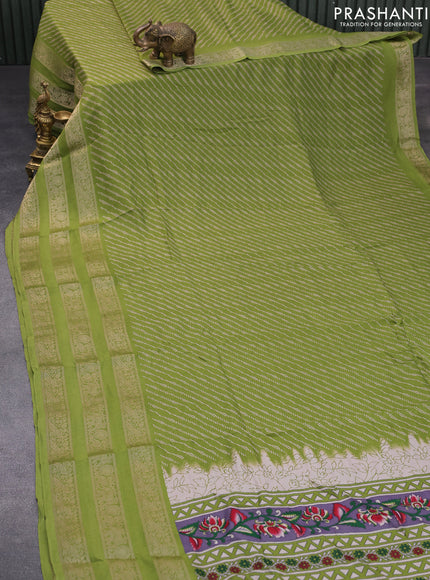 Semi georgette saree light green with allover prints and long zari woven border