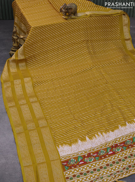 Semi georgette saree mustard yellow with allover prints and long zari woven border