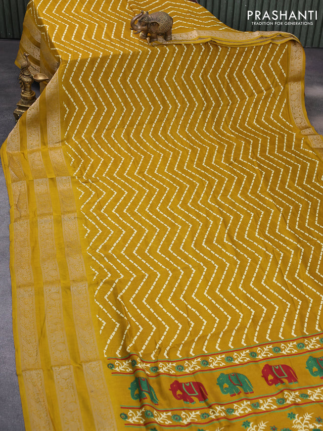 Semi georgette saree mustard yellow with allover zig zag prints and long zari woven border