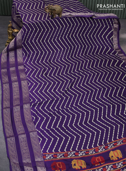 Semi georgette saree deep violet with allover zig zag prints and long zari woven border