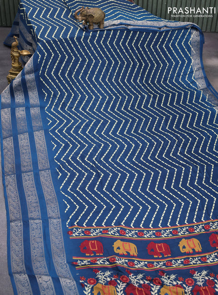 Semi georgette saree peacock blue with allover zig zag prints and long zari woven border