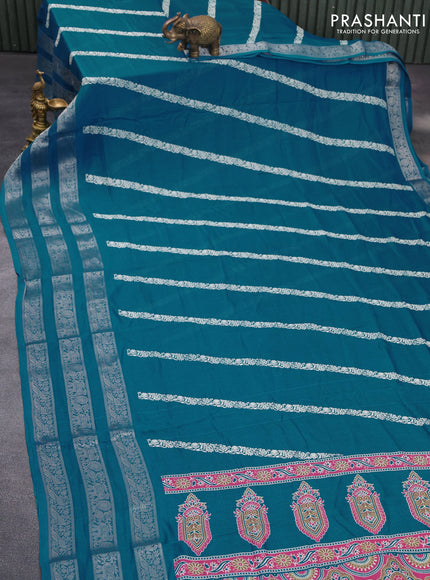 Semi georgette saree cs blue with allover prints and long zari woven border