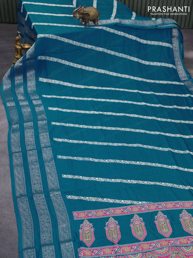 Semi georgette saree cs blue with allover prints and long zari woven border