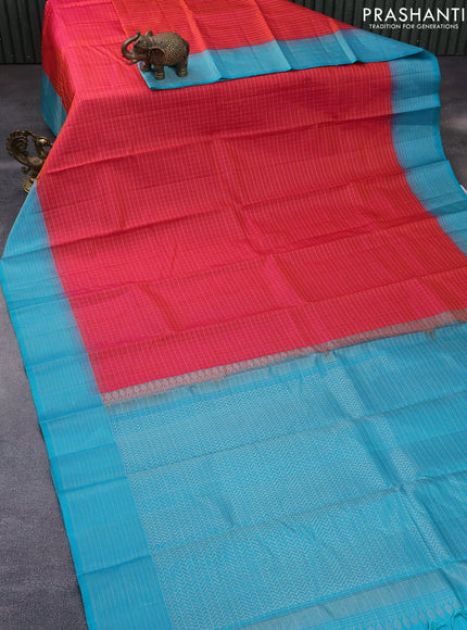 Pure soft silk saree dual shade of pinkish orange and teal blue with allover zari checked pattern and zari woven border