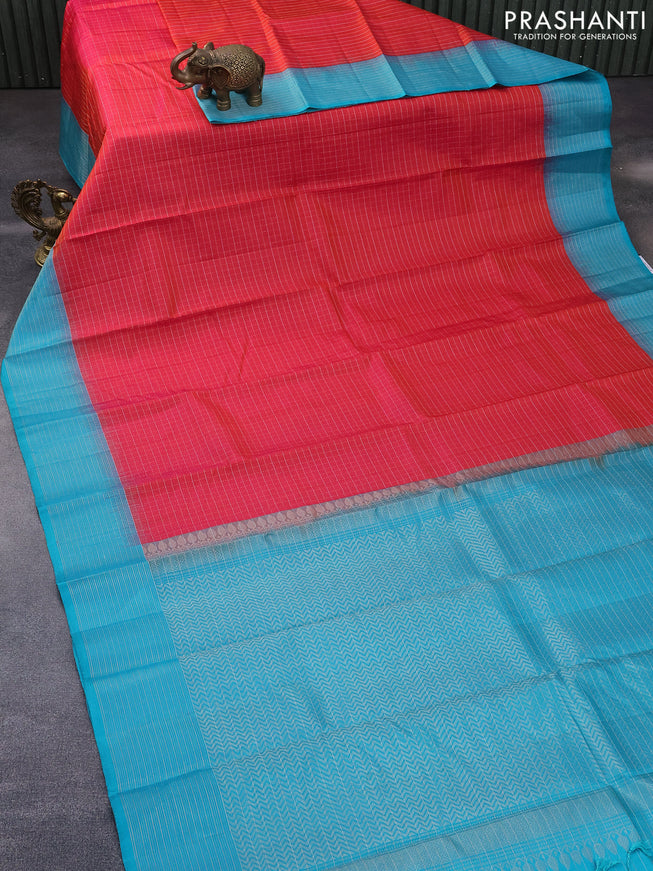 Pure soft silk saree dual shade of pinkish orange and teal blue with allover zari checked pattern and zari woven border