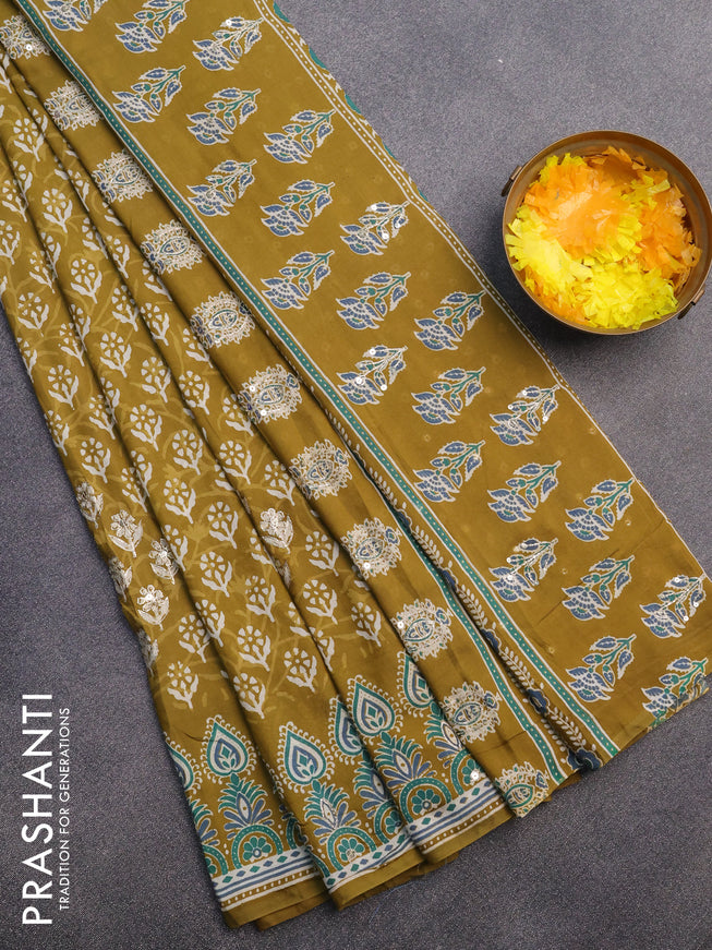 Muslin silk saree mehendi green and teal green with allover dabu prints & pita work and ajrakh printed border