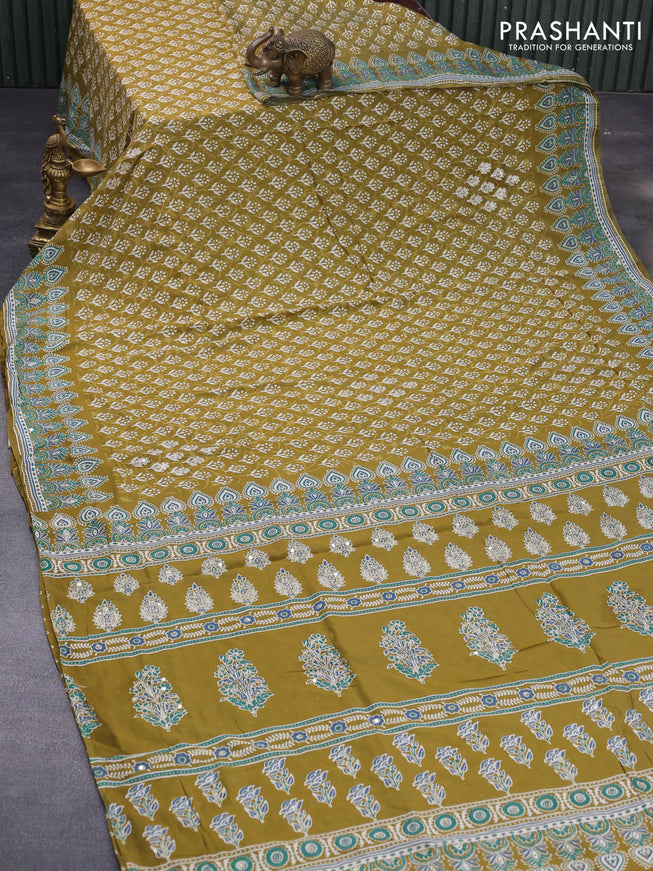 Muslin silk saree mehendi green and teal green with allover dabu prints & pita work and ajrakh printed border