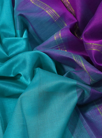 Silk cotton saree teal blue and violet with plain body and floral & paisley zari woven border